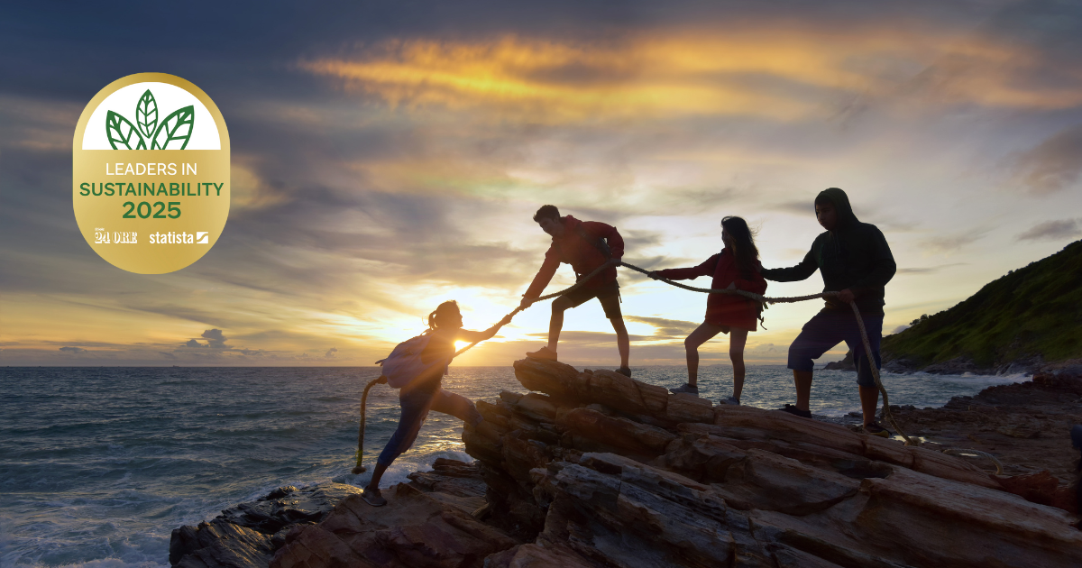 Silhouettes of four people on a rocky coast at sunset, with one person helping another up a rock, and a "Leaders in Sustainability 2025" badge in the top left corner.