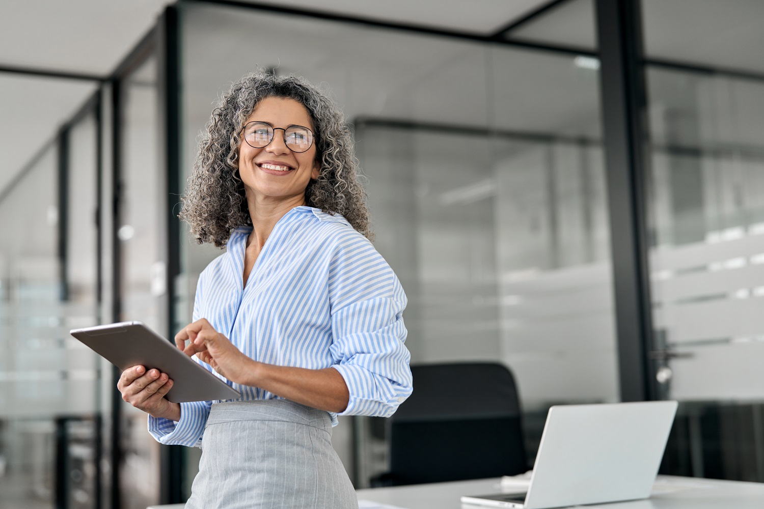 a professional and smiling woman in the office 